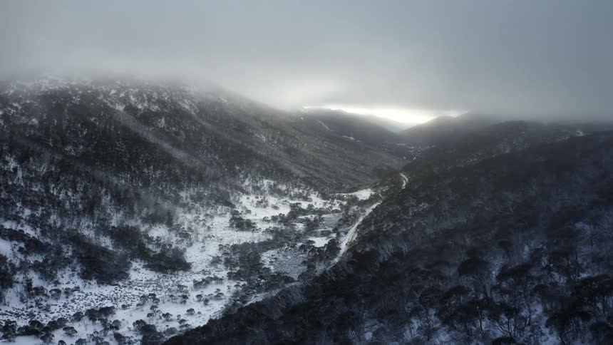 An aerial view of a mountain with snow on it