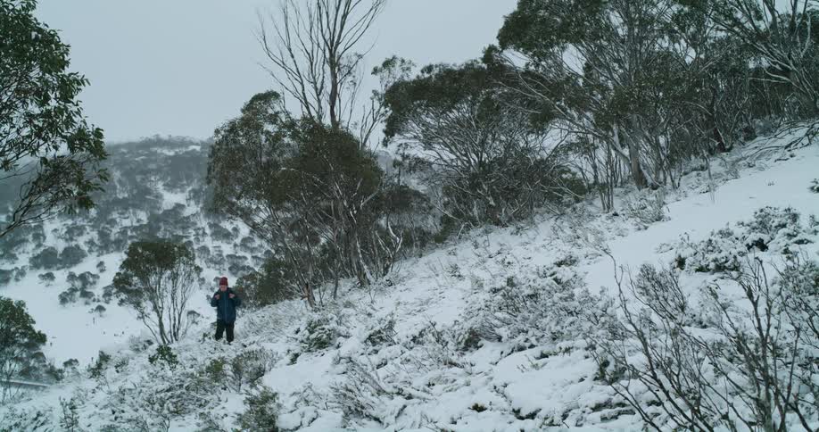 A person walks across a snowy field