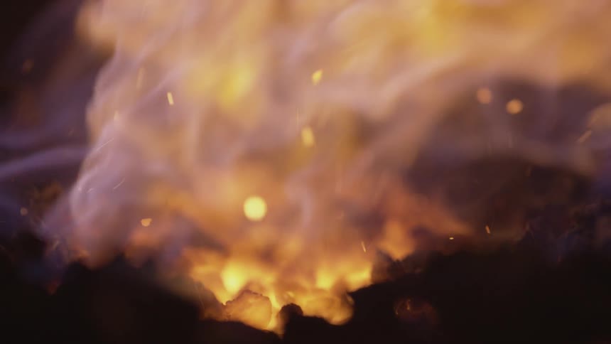 A fire blazes in the dark