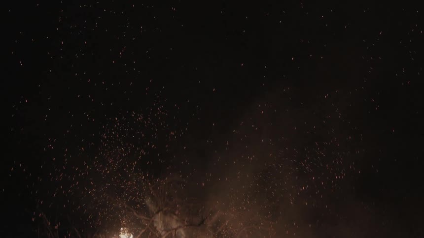 Fires blaze in a dark field