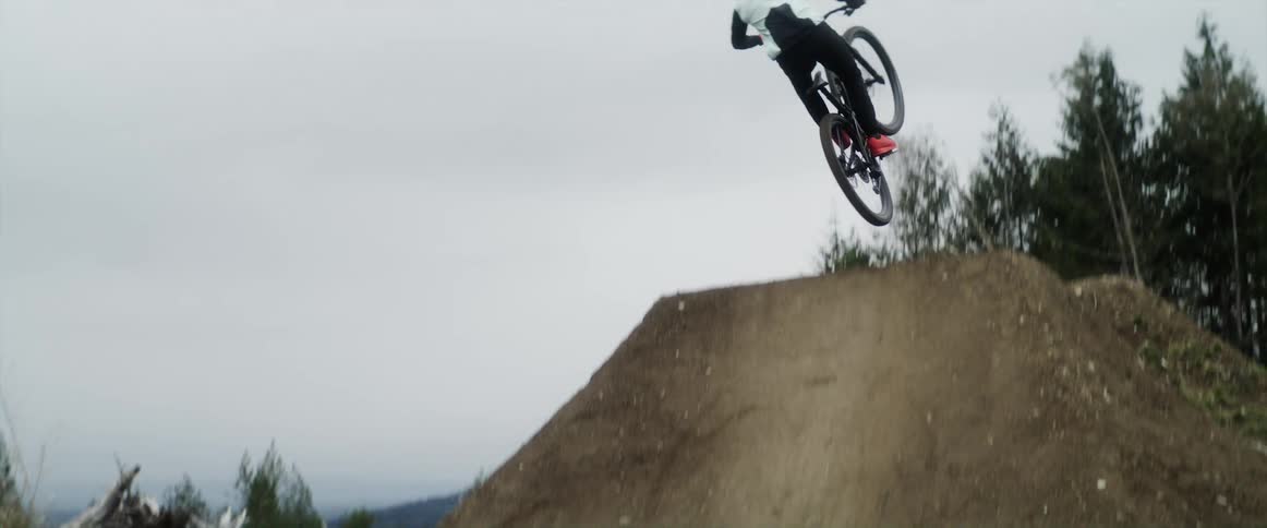 A person jumping a bike on a large jump