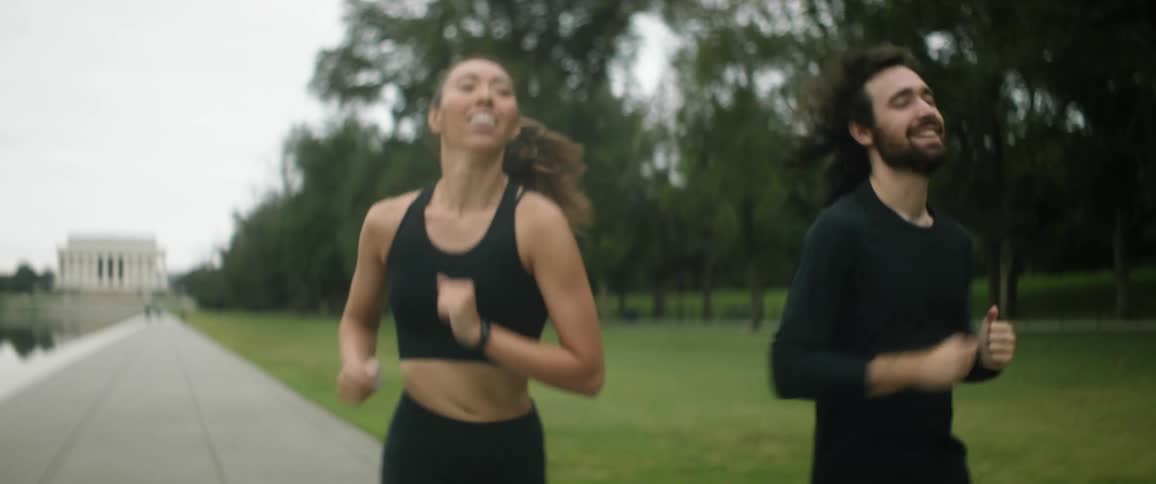 Two people running outside