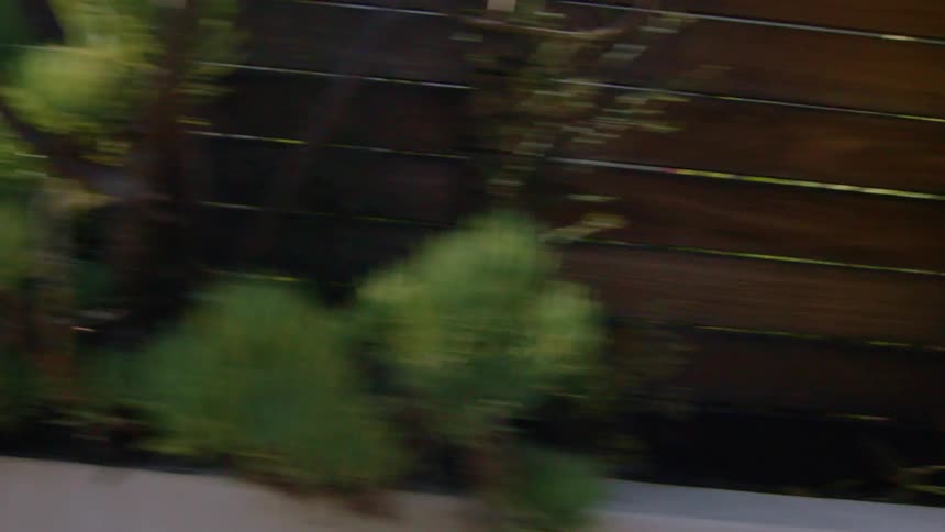 Vehicle passes by wood fences