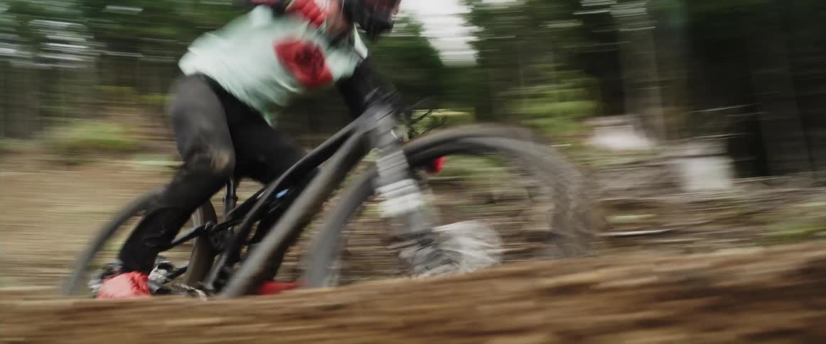 A person riding a bicycle through a forest