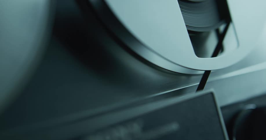 Close up of the spinning rolls on a vintage tape recorder