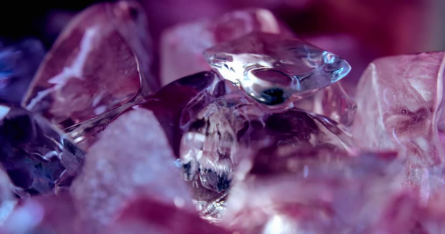 Light reflects on the surface of colorful shimmering crystals