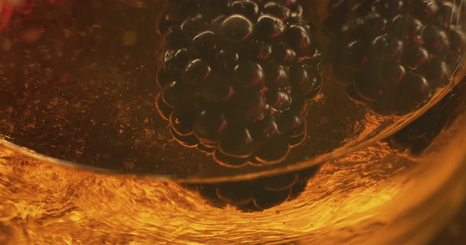 A close up of blackberries are shown under a microscope