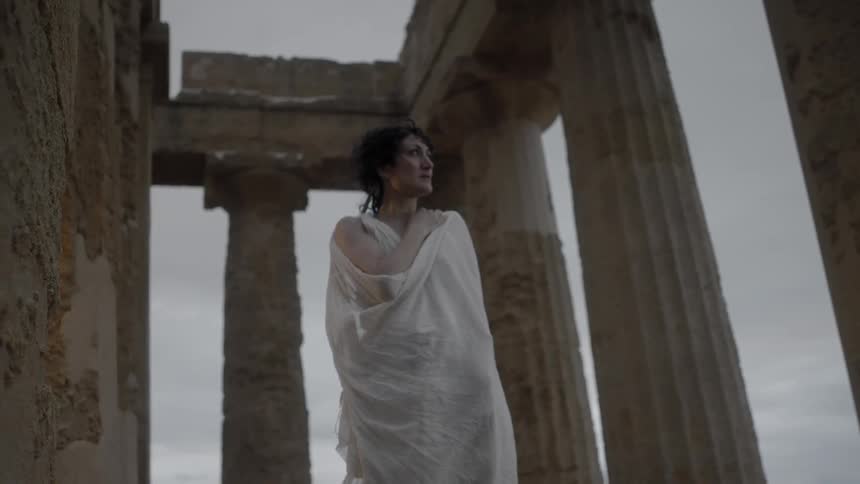 A woman at the acropolis on a windy, overcast day