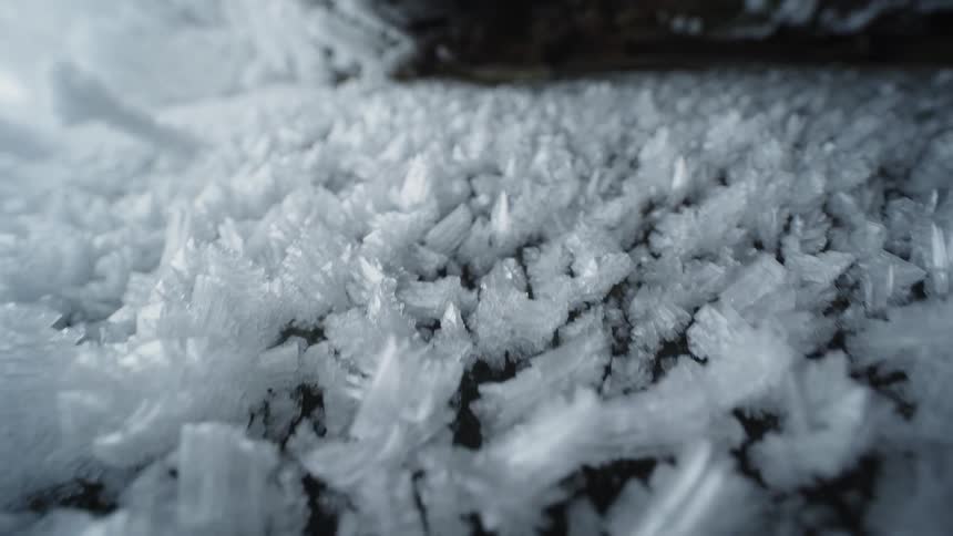Ice covers road near snow covered slope