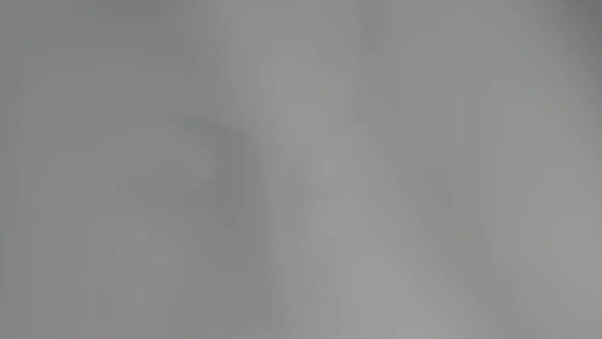 A woman's face as a breeze blows thin material in front of her face