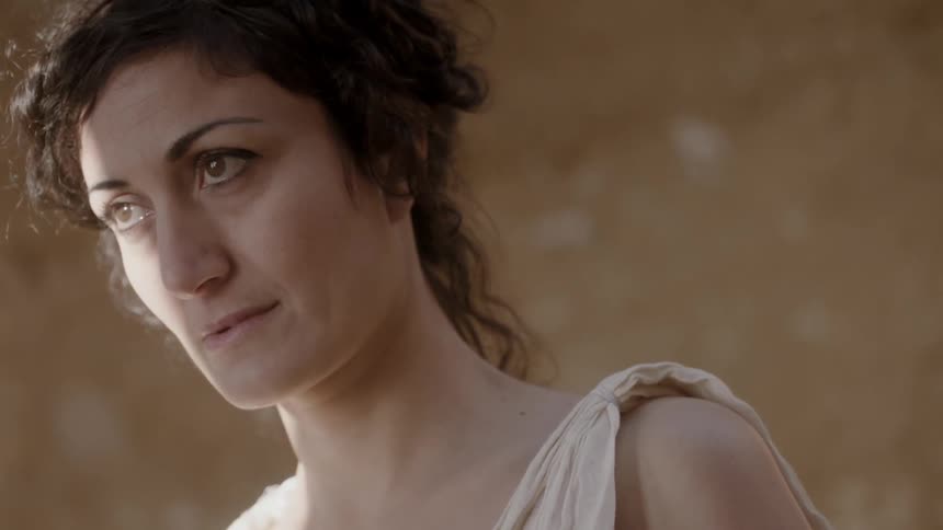 A woman is looking down before looking forward