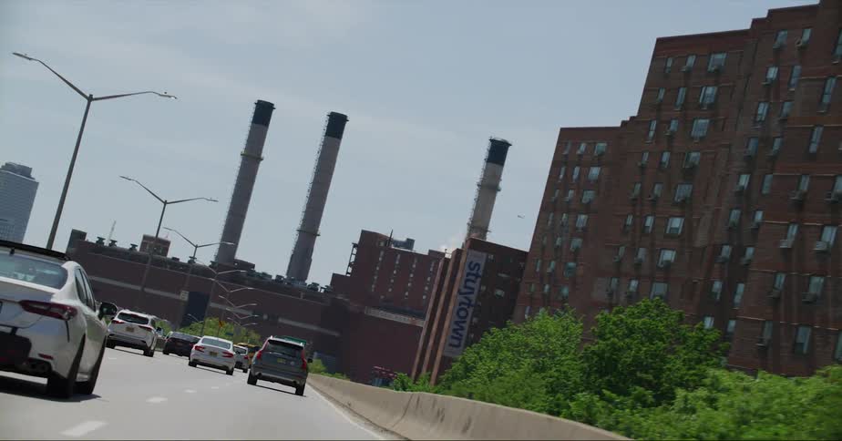 Traffic travels along a freeway through a metropolis during the day