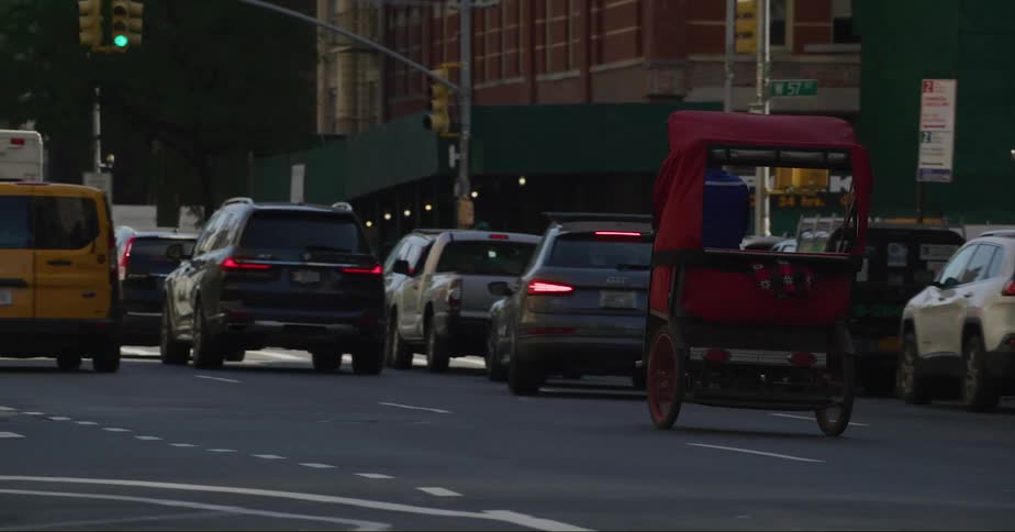 A city street with people walking and cars driving