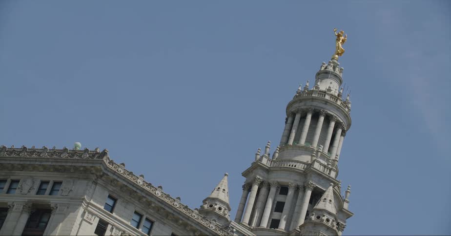 A gold statue is at the top of the building