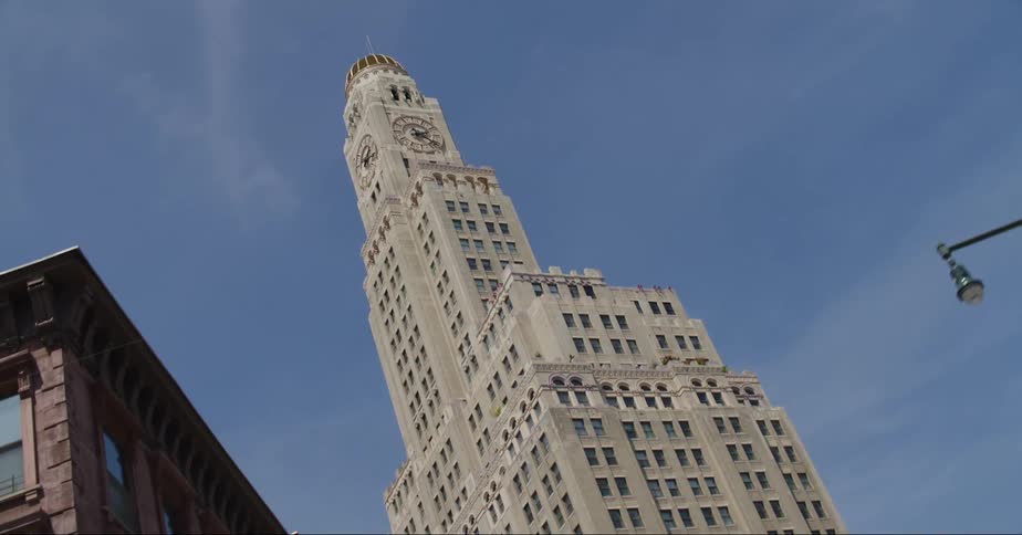 A skyscraper stands tall among buildings on a downtown street