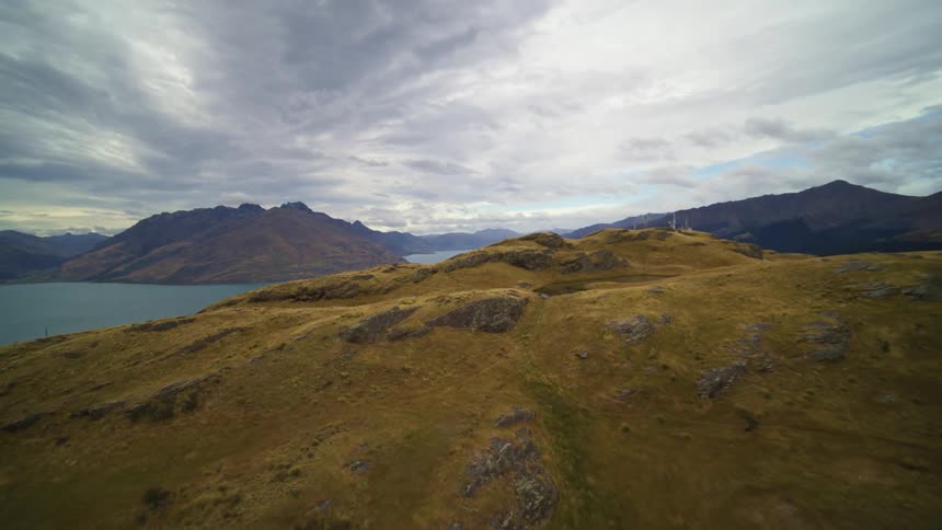 The hills are barren by the water