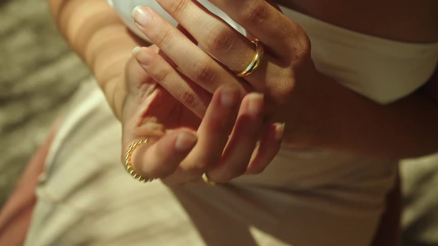 A woman puts on a ring