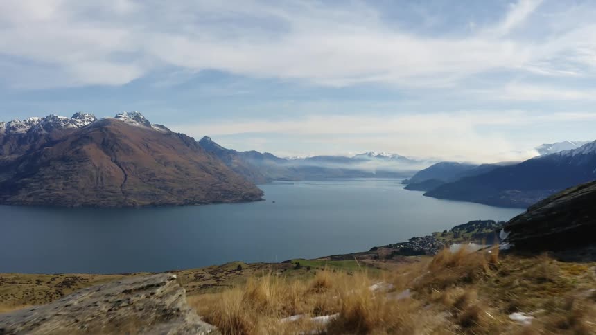 Panoramic view of native grassland on the shore of a lake in the mountains