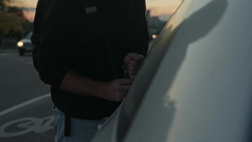 A man is breaking into the vehicle