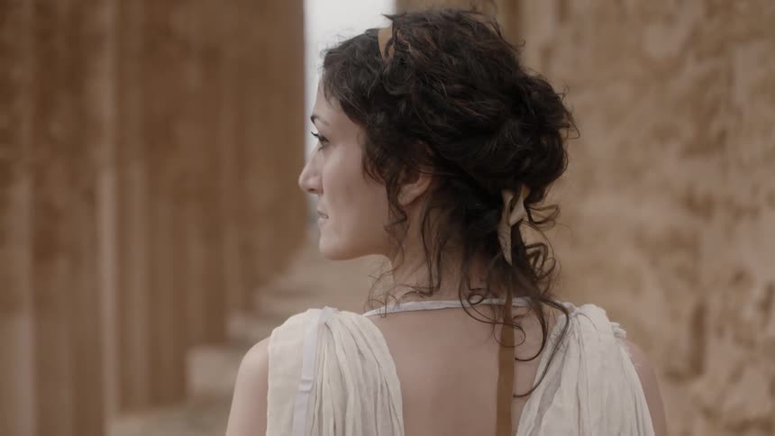 A woman looks over to her side on a cloudy day