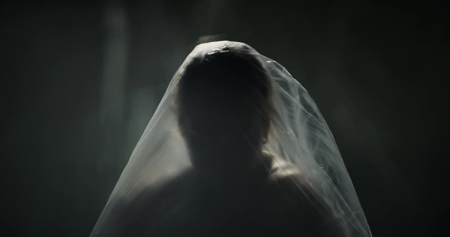 A person is moving under the plastic sheet