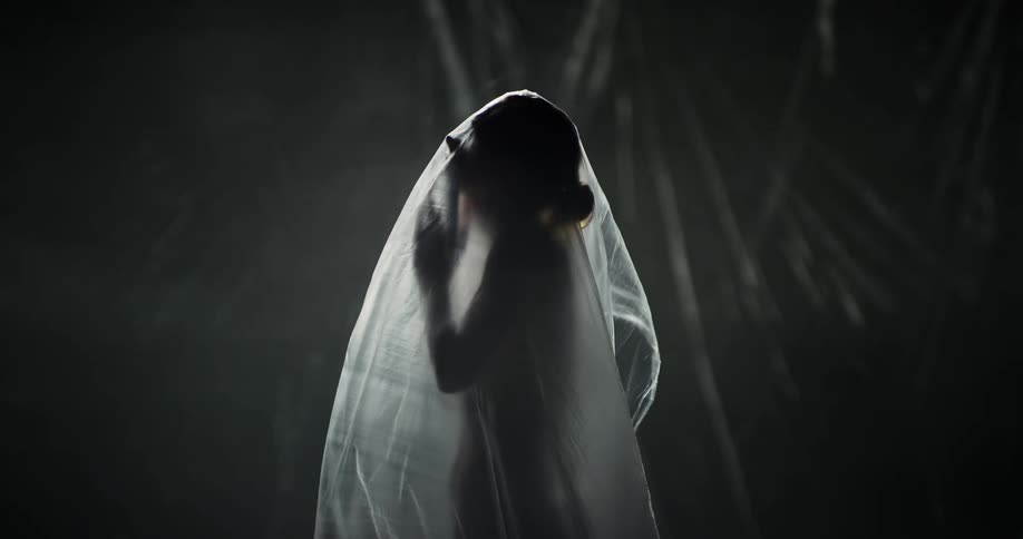 A woman moves around under the plastic sheet