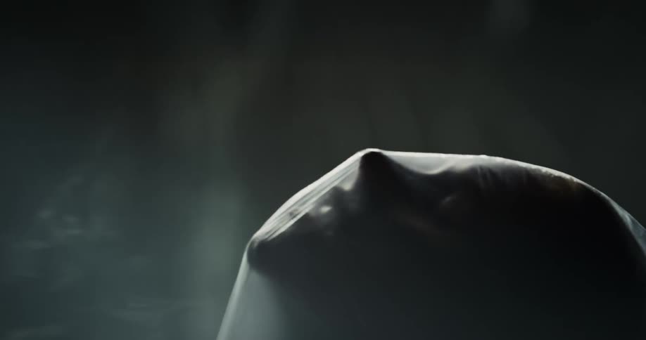 Close up of a woman turning her face which is covered in plastic