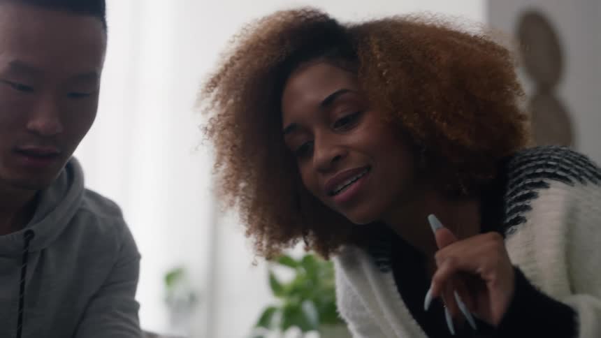 A man and woman use a cell phone together