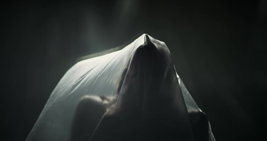 A woman is moving under the plastic sheet