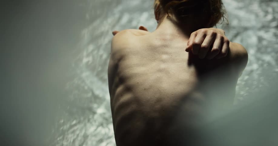 A woman is hugging herself