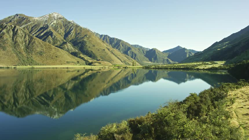 Beautiful landscape of calm reflective lake and mountains