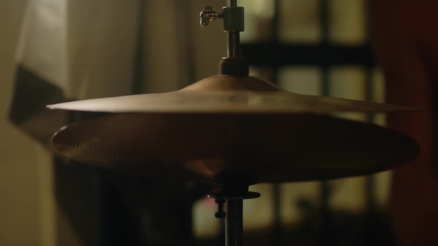 A man stands up and walks away after playing the drums