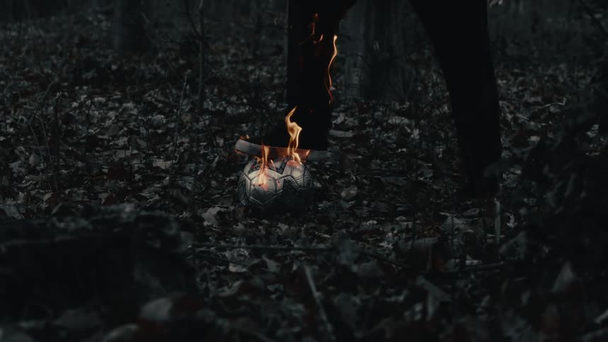 A person catches fire while stepping on a burning soccer ball