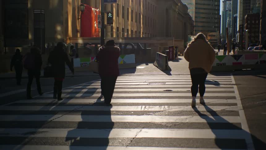 People crossing a street in a downtown area