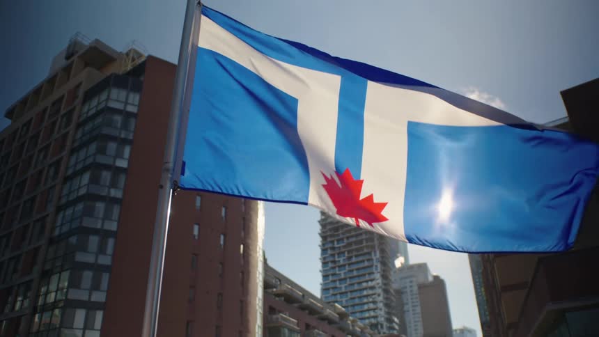 A flag blows in the wind in front of apartment buildings
