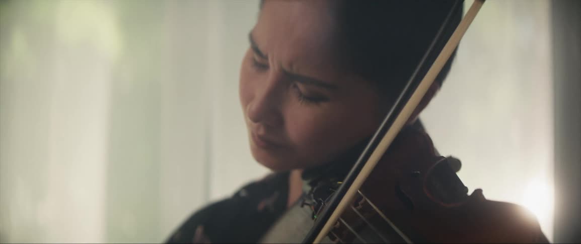 A woman is playing the violin