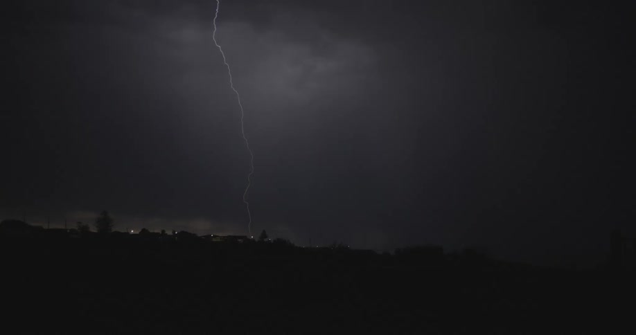 Thunder and lightning flash through the thick clouds at night