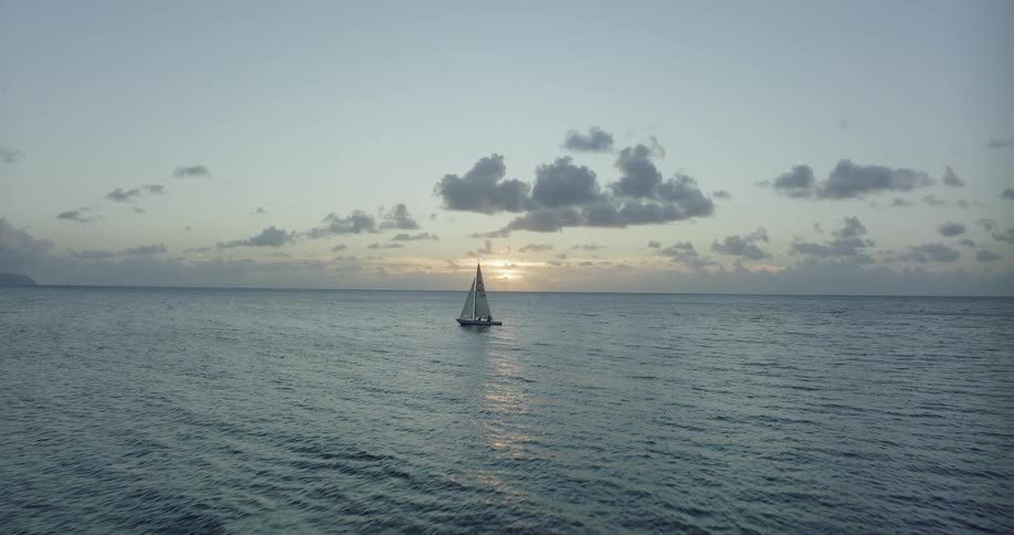 The small sailboat travels in the ocean