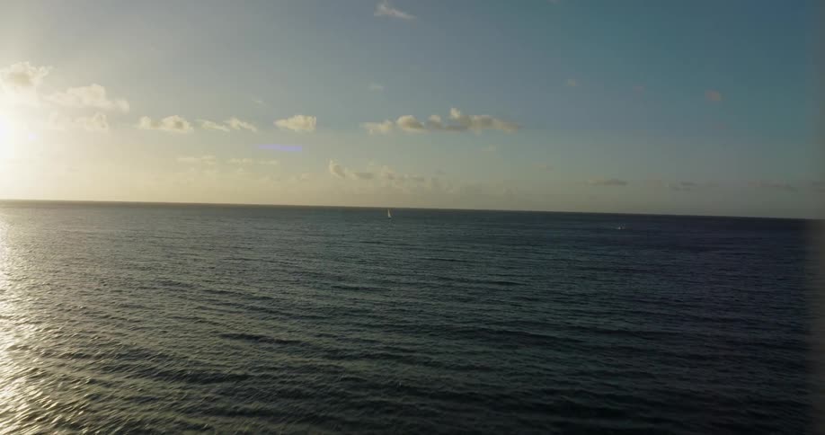 The rising sun reflects on the ocean