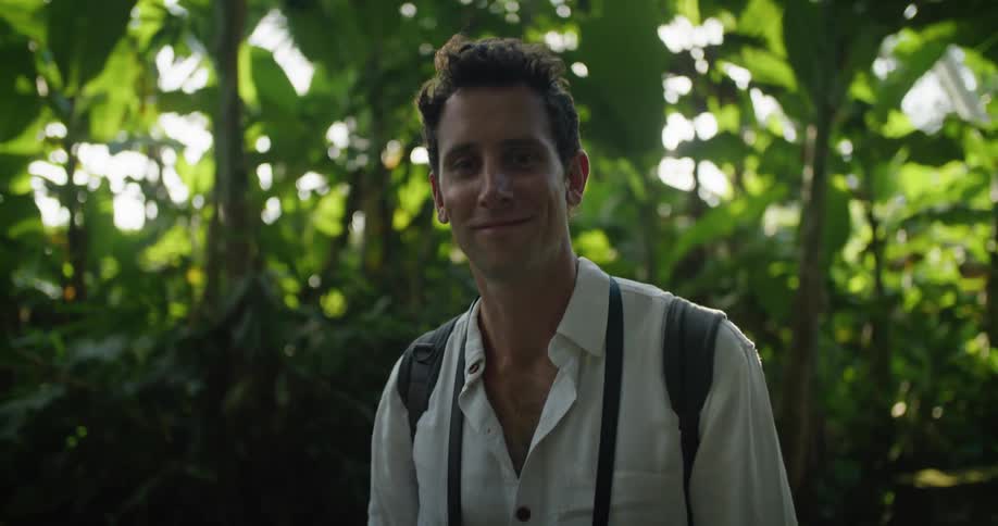 A man smiles in the jungle