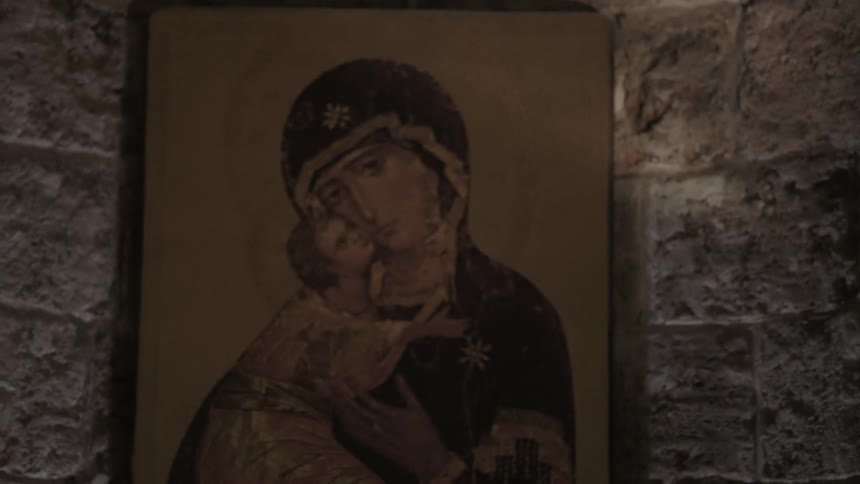 Painting of a woman holding a baby in an old building