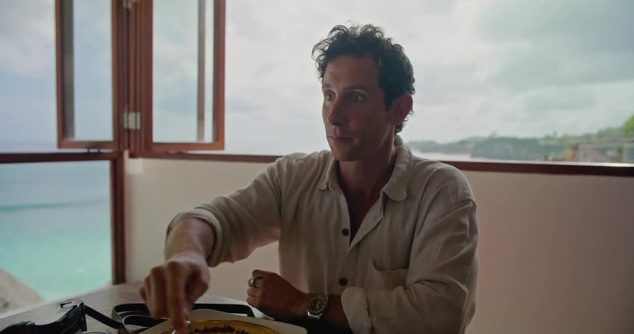 Photographer puts the camera on the table and starts eating while talking to a friend