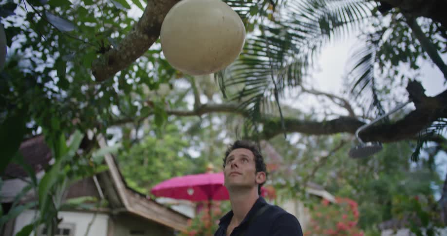 Young man inspecting the common areas of a tropical resort