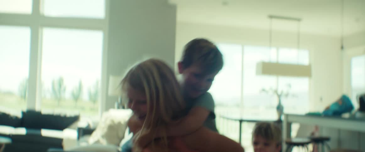Girl gives piggyback ride while running through the house