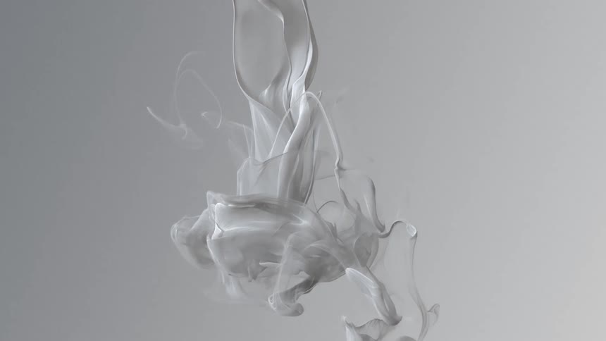 Pale gray mass falls and expands becoming filmy ribbons against a gray background