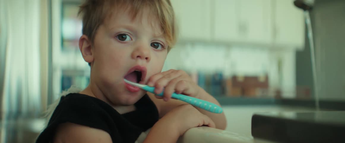 A child is brushing his teeth