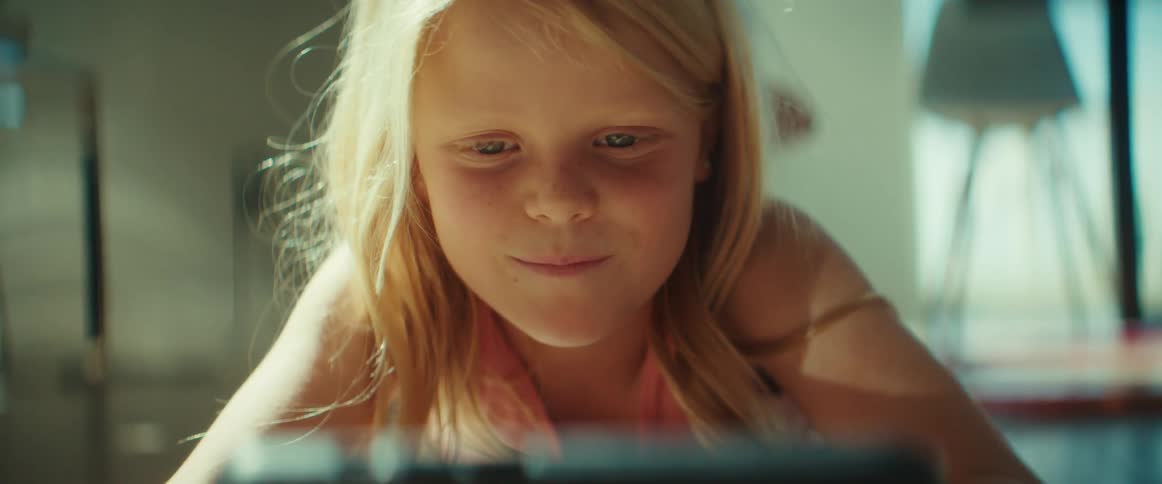 A girl is playing a portable video game