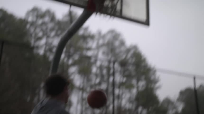 Two men shoot hoops together
