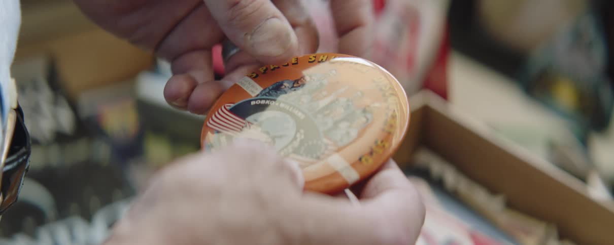A person puts a button in the box