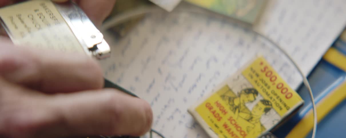 Close up of a man's hands holding an old lighter in drawer